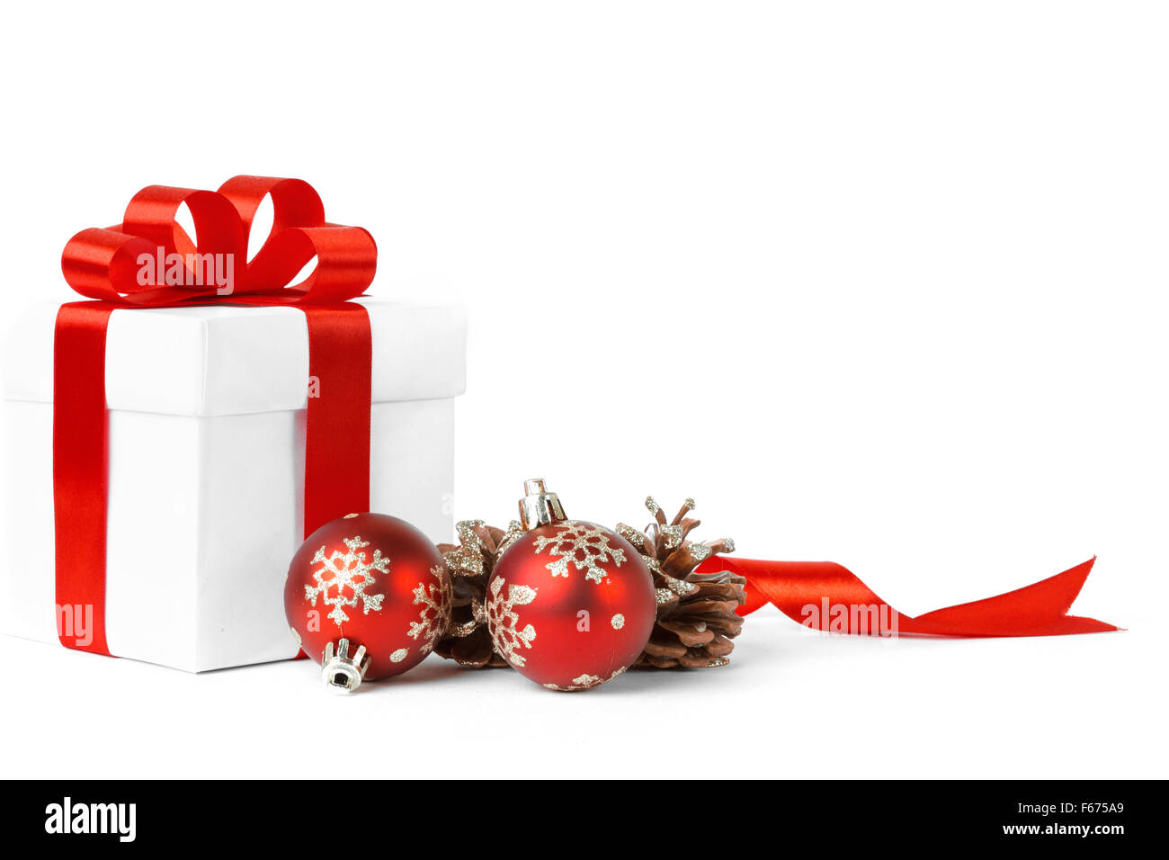 christmas gift with red balls bow Stock Photo - Alamy