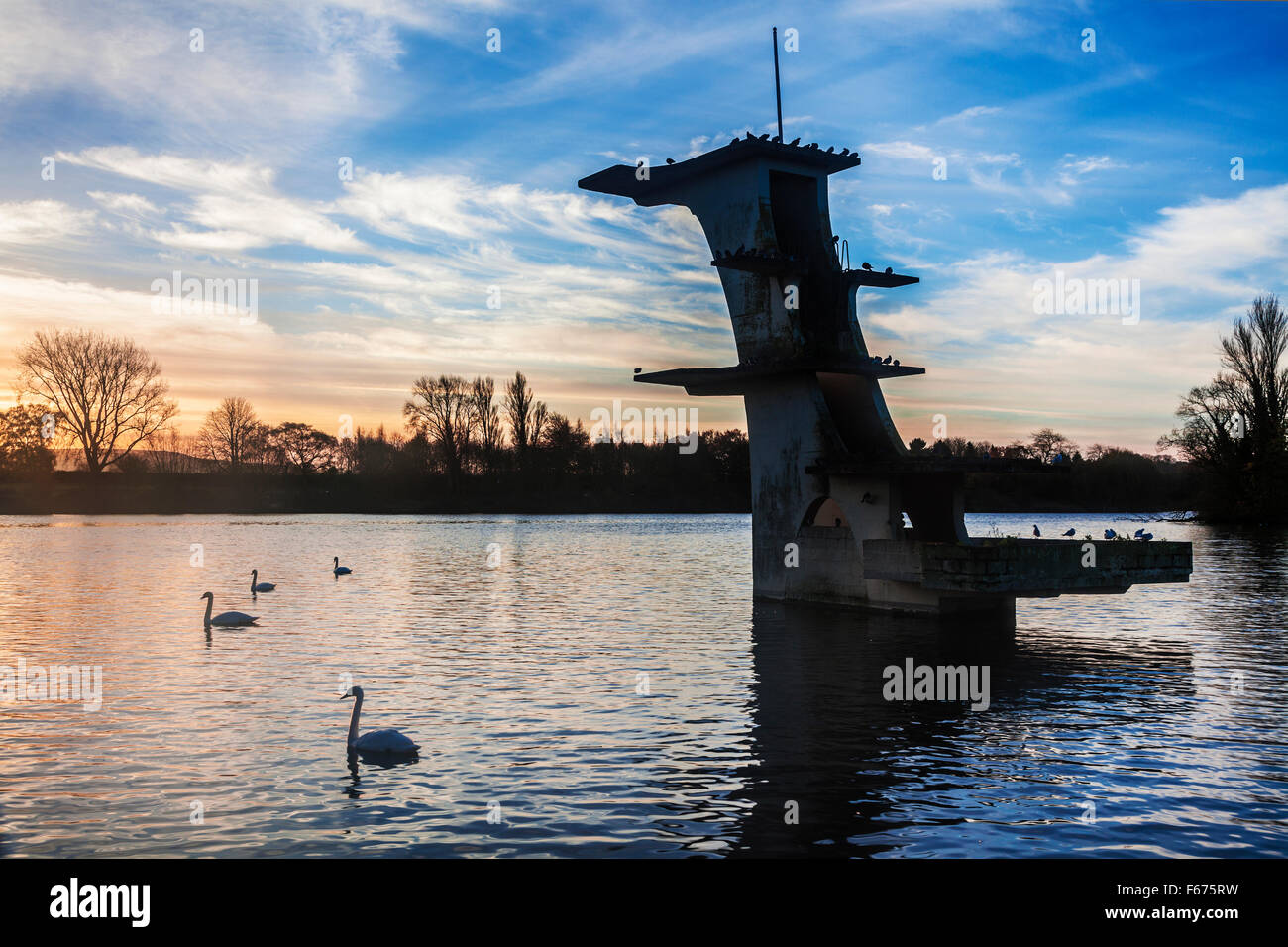 The old diving board at Coate Water in Swindon at dawn. Stock Photo