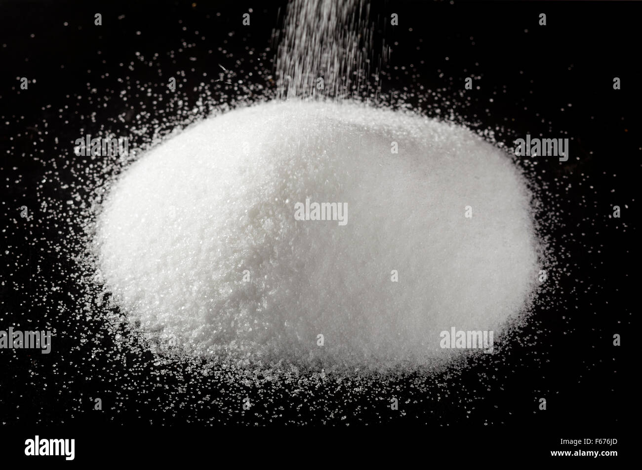 Sugar on dark surface Stock Photo