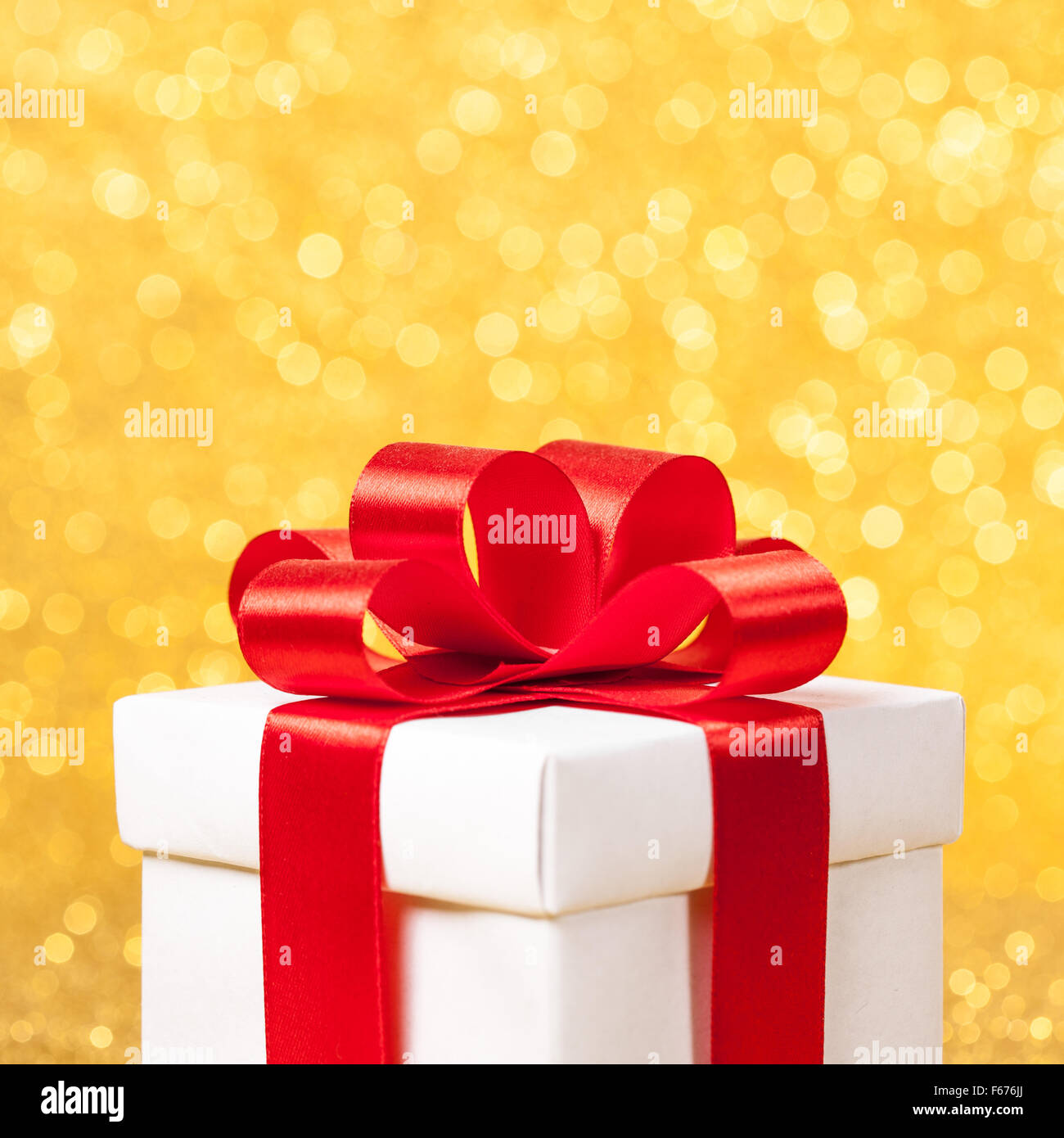 White gift box with red ribbon bow Stock Photo - Alamy