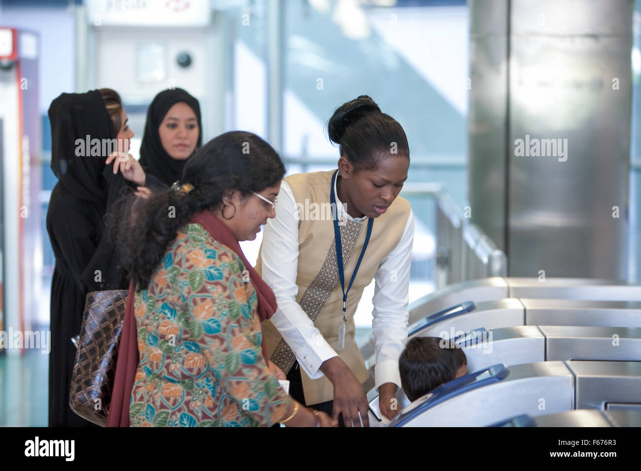 Staff of the Dubai Metro assisting the public. Stock Photo