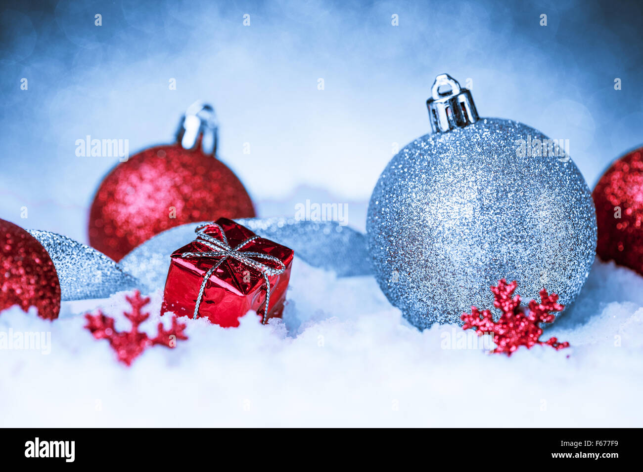 christmas ornament in snow on glitter background Stock Photo - Alamy