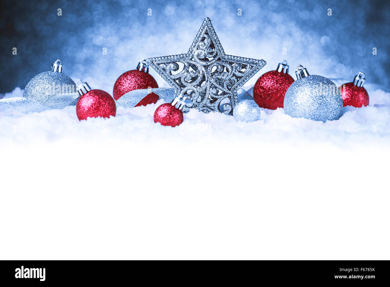 christmas ornament in snow on glitter background Stock Photo - Alamy