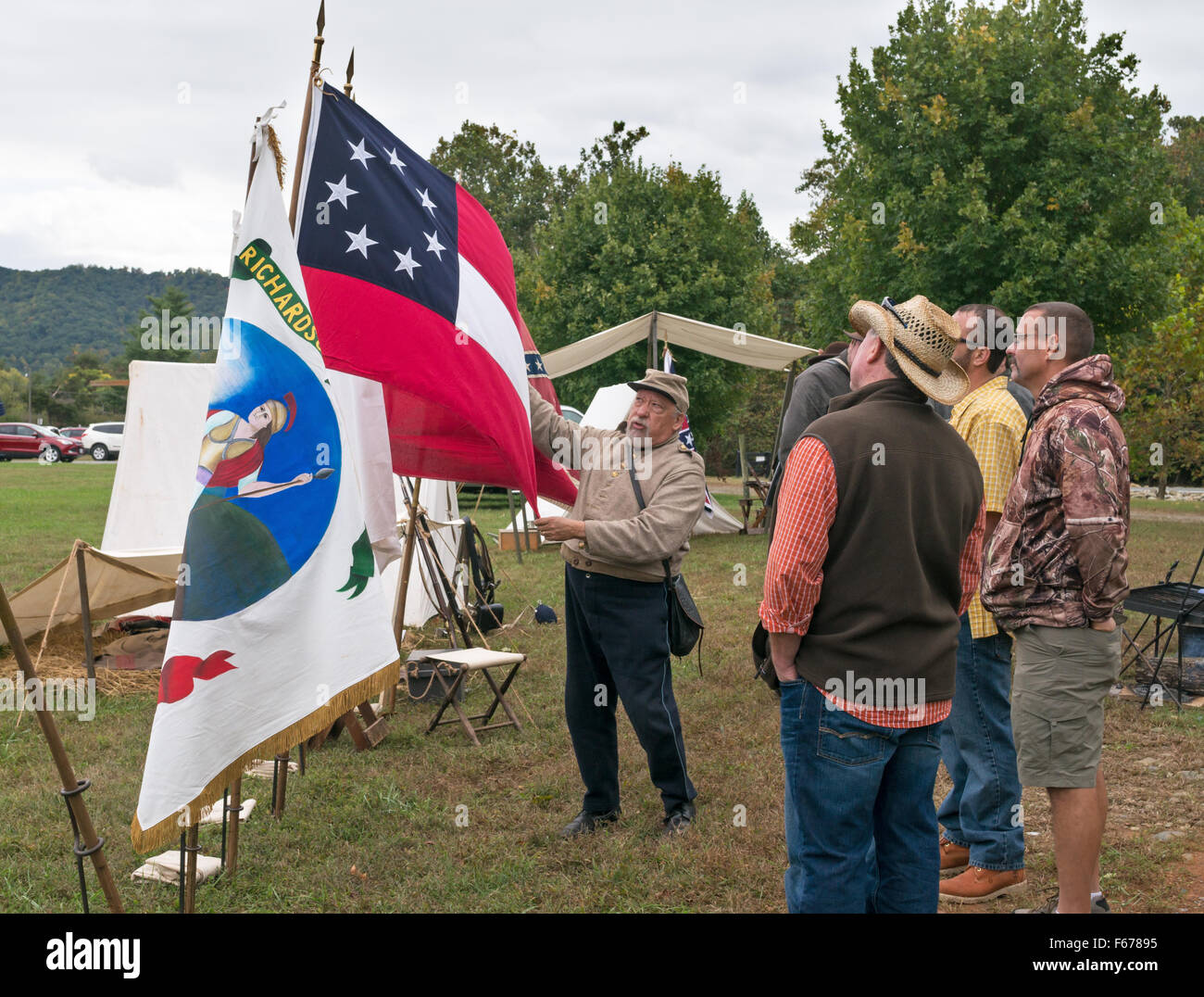Reenactor explaining old Confederate National Flag at Graves' Mountain Apple Harvest Festival, Virginia, USA Stock Photo
