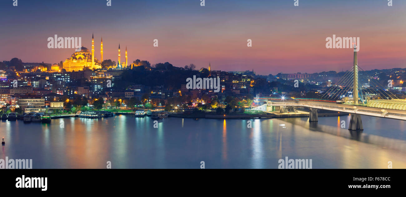 Istanbul Panorama. Panoramic image of Istanbul with Suleymaniye Mosque and Golden Horn Metro Bridge at sunset. Stock Photo