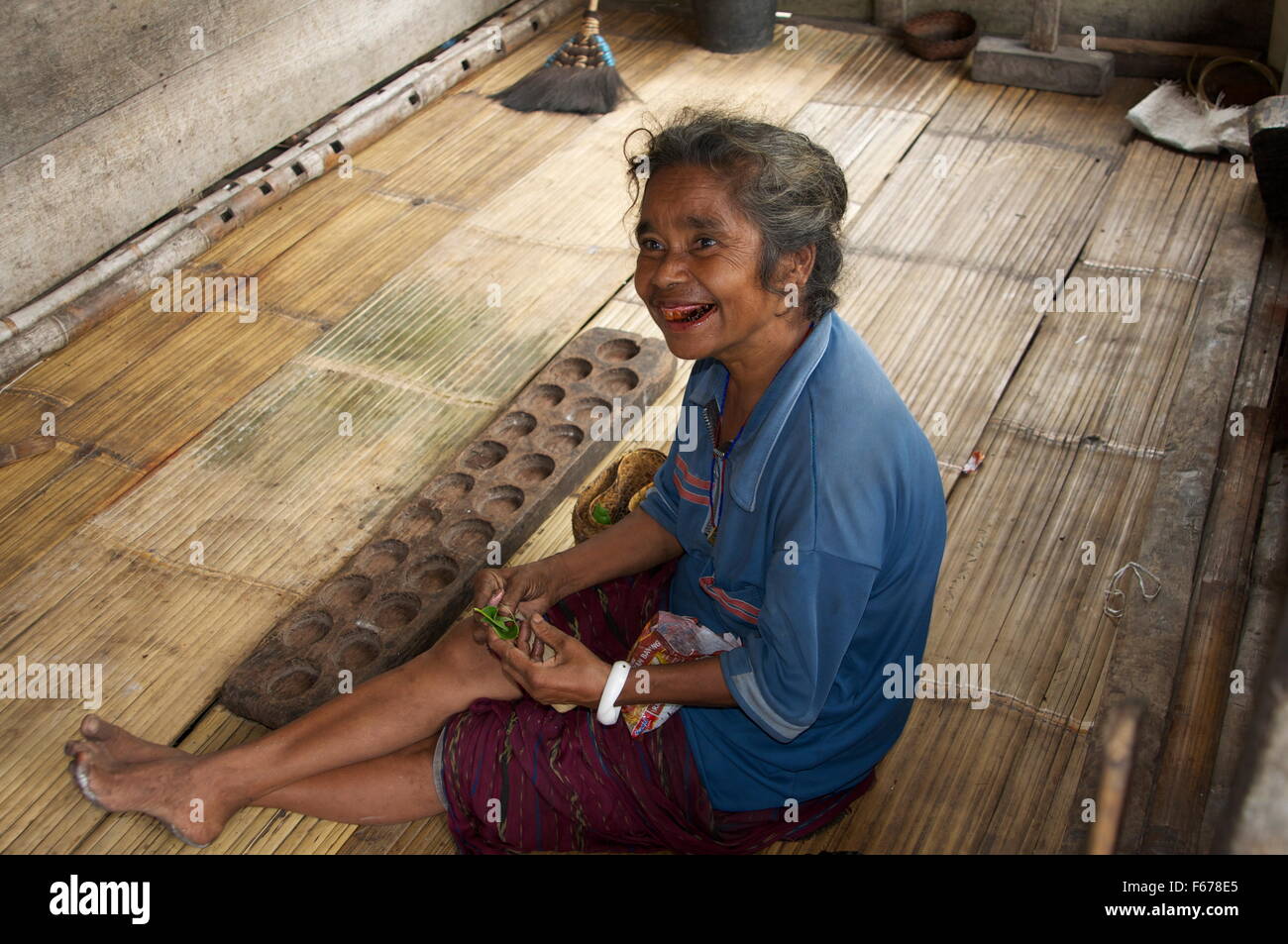 Woman playing the traditional game congkak Stock Photo