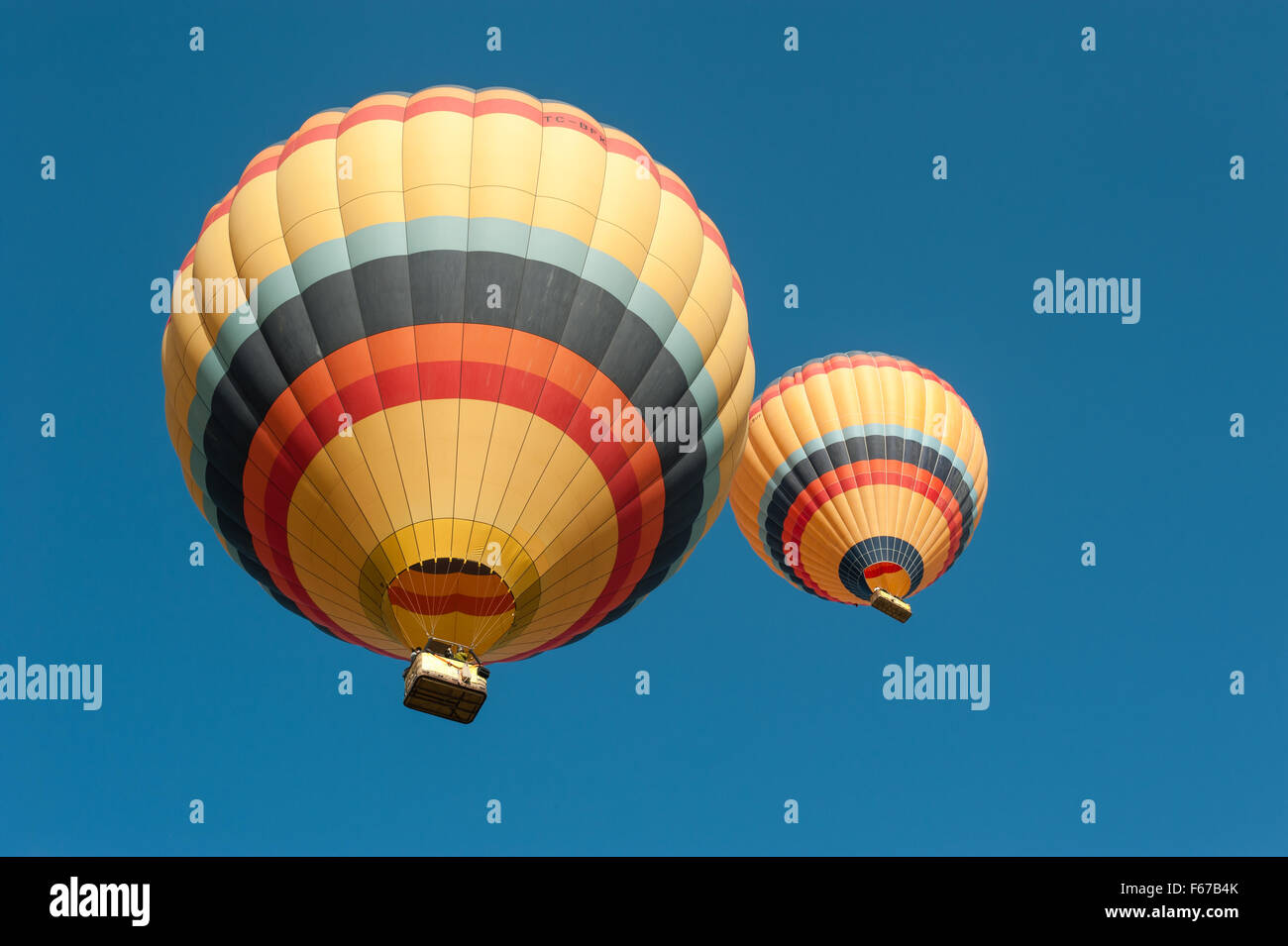 Two balloons with a clear blue sky in Cappadocia, Turkey. Stock Photo