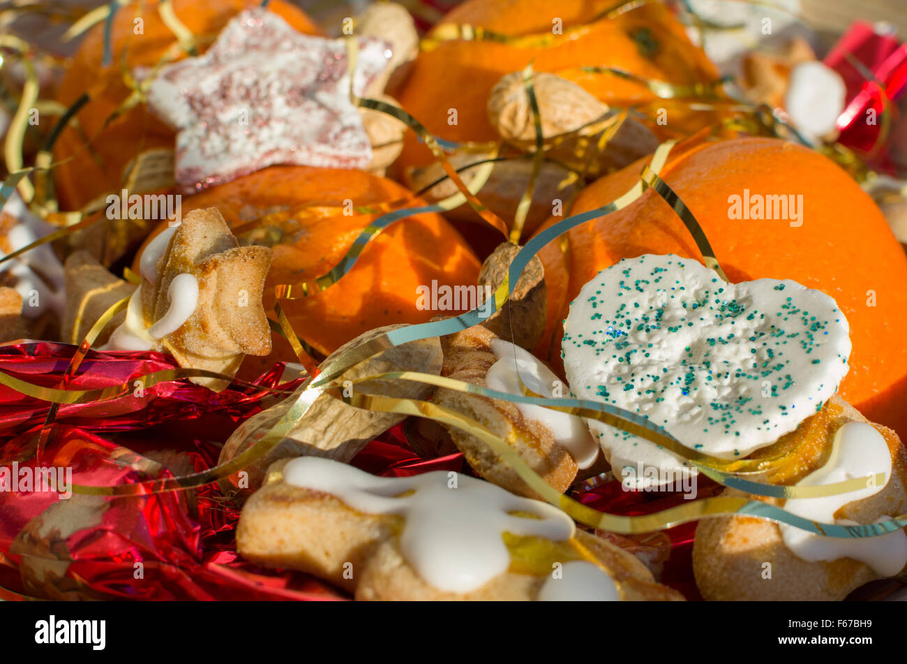 Christmas Still with Oranges Peanuts and Heart Decoration Covered with Angel Hair Closeup Stock Photo
