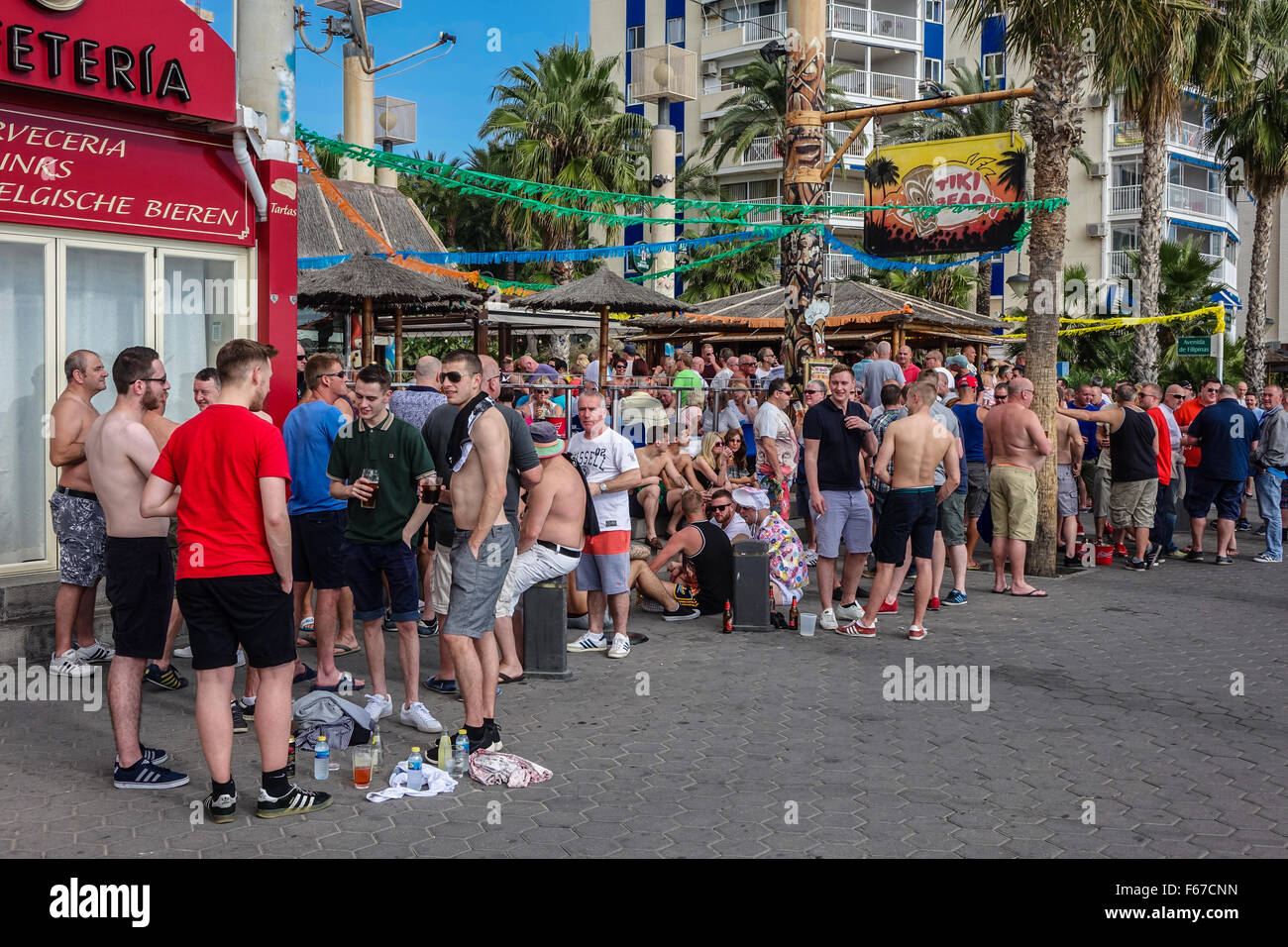 Benidorm, Spain. 13th November, 2015. England supporters begin to fill the bars in the resort of Benidorm, north of Alicante. The Spain versus England friendly match is due to kick off tonight, Friday in Alicante. Crowds outside the beachfront Tiki bar Credit:  Mick Flynn/Alamy Live News Stock Photo