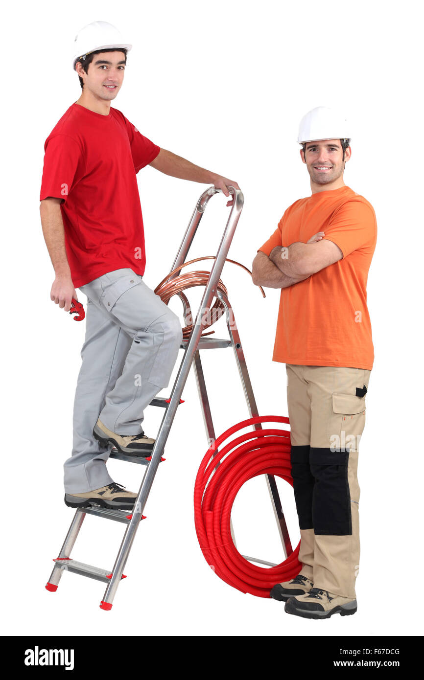 Two plumbers stood with ladder Stock Photo Alamy