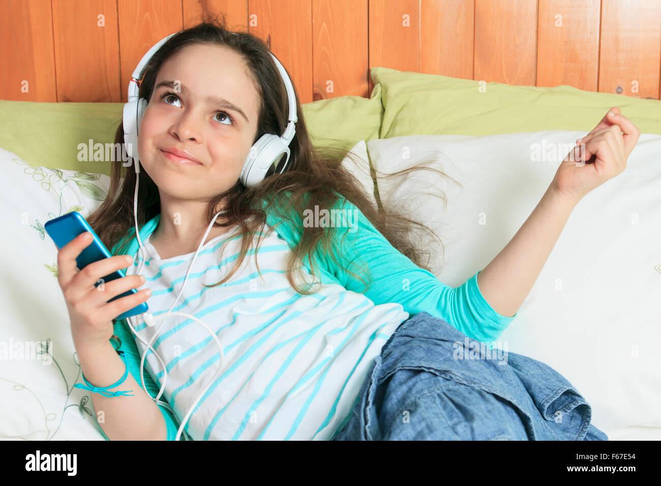 Child music listening bed Stock Photo