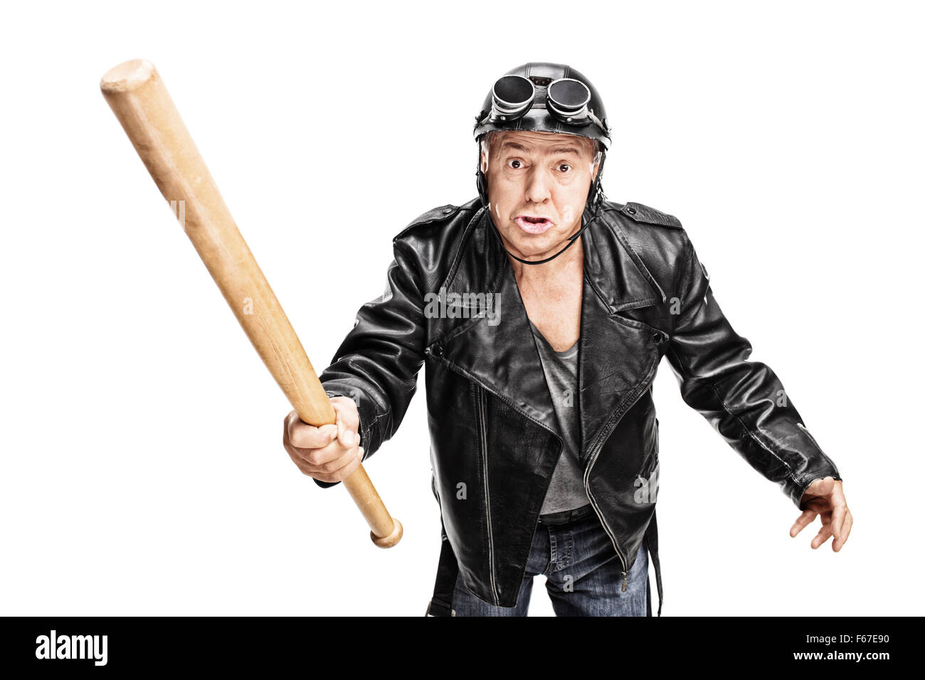 Angry and violent senior biker swinging with a baseball bat isolated on white background Stock Photo