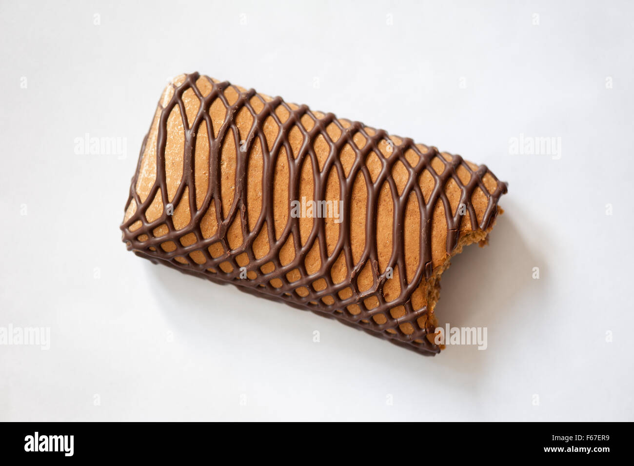 Bitten gingerbread sweet bar snack decorated with chocolate, candy sweets with decorative pattern milk chocolate icing ... Stock Photo