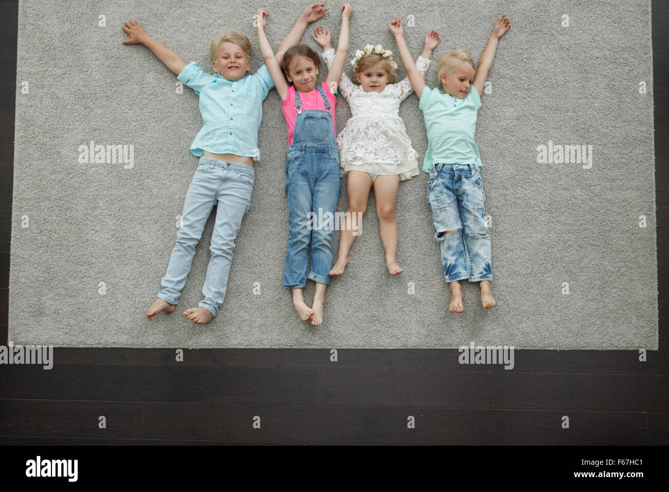 Group of happy kids laying on floor, top view Stock Photo Alamy