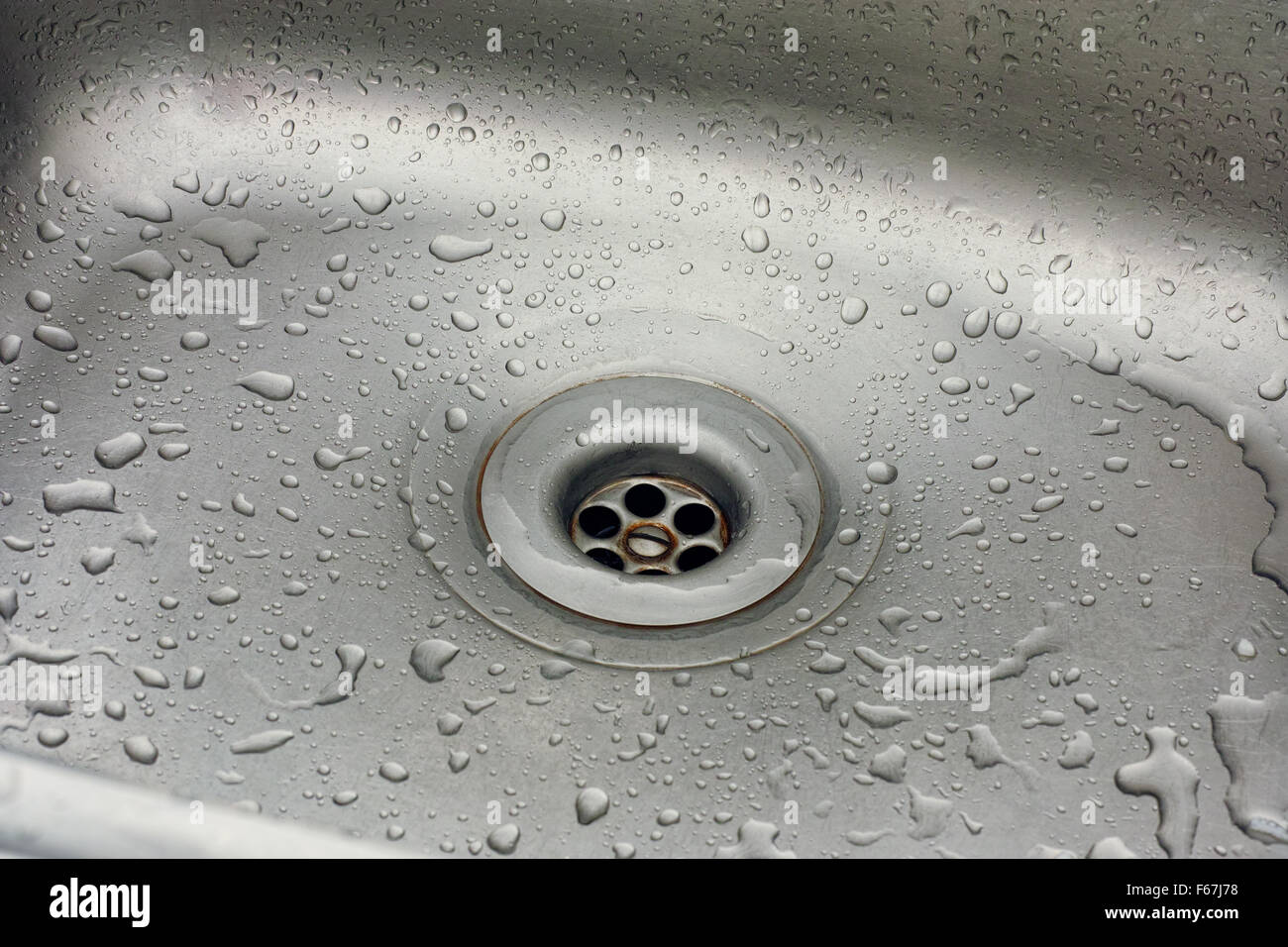 Sink with water drops. Plug hole of a kitchen sink Stock Photo Alamy