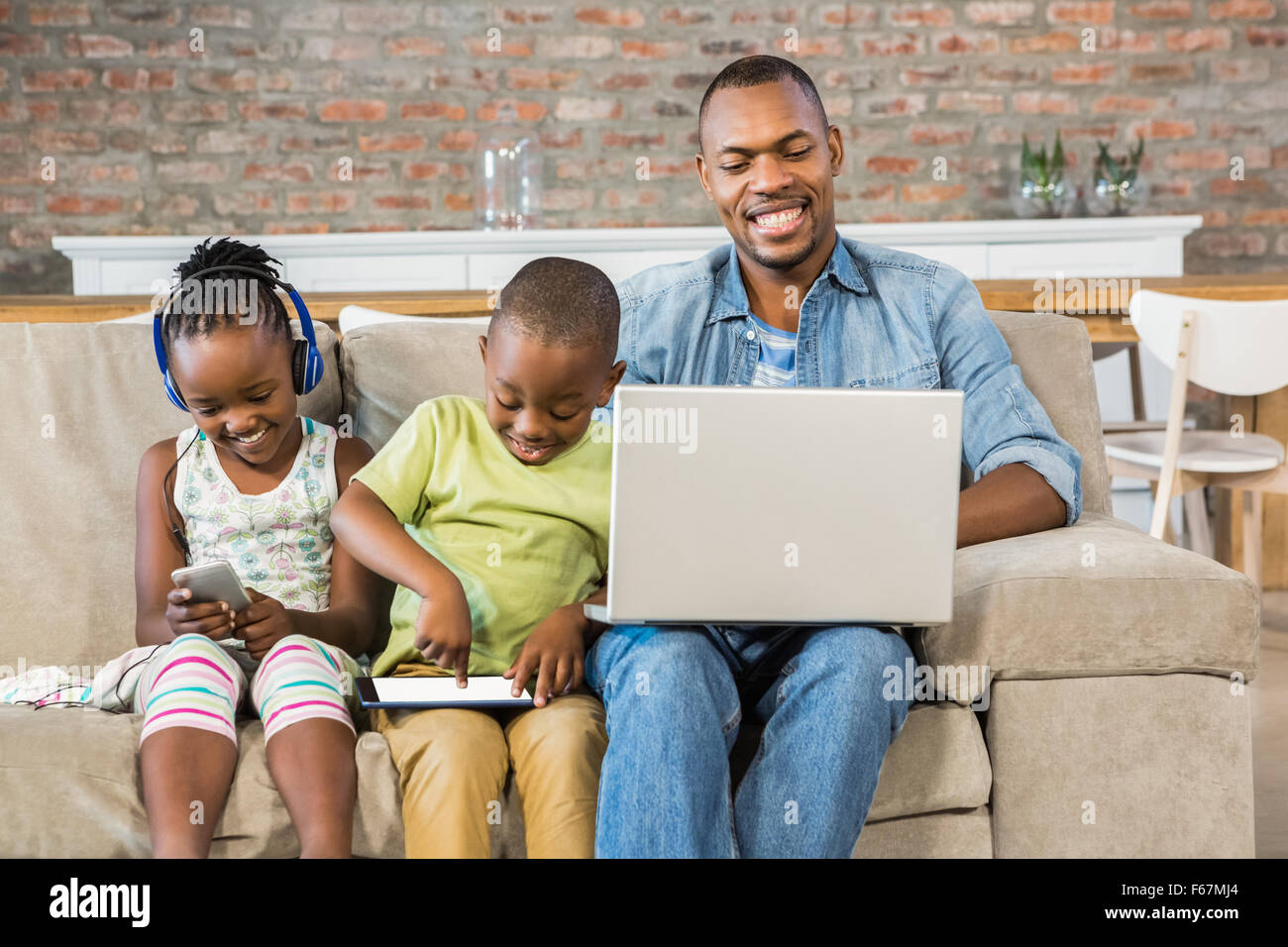 Happy family using technology together Stock Photo - Alamy