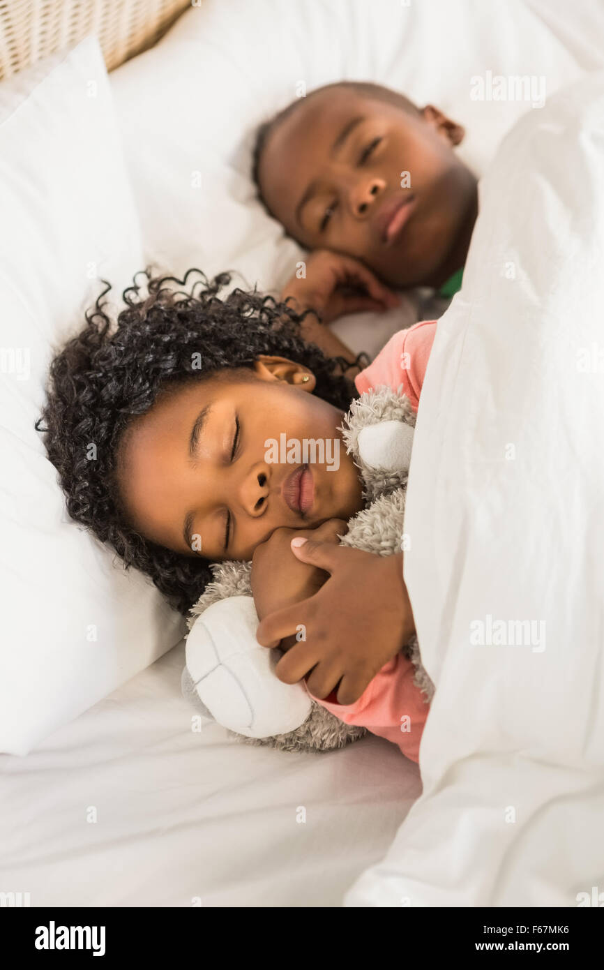 Cute siblings sleeping together Stock Photo Alamy