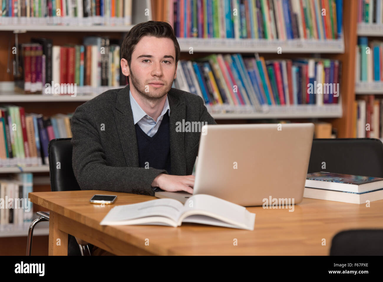 Guy In Library In The Library - Handsome Male Student With Laptop And Books Working In ...