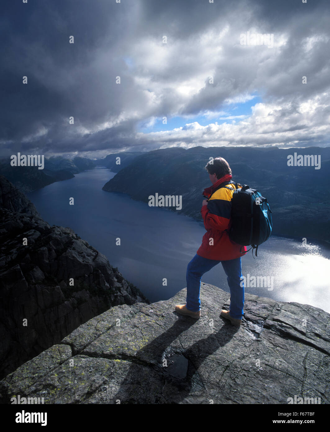 Norway, Preikestolen, Hiker at edge of the cliff Stock Photo