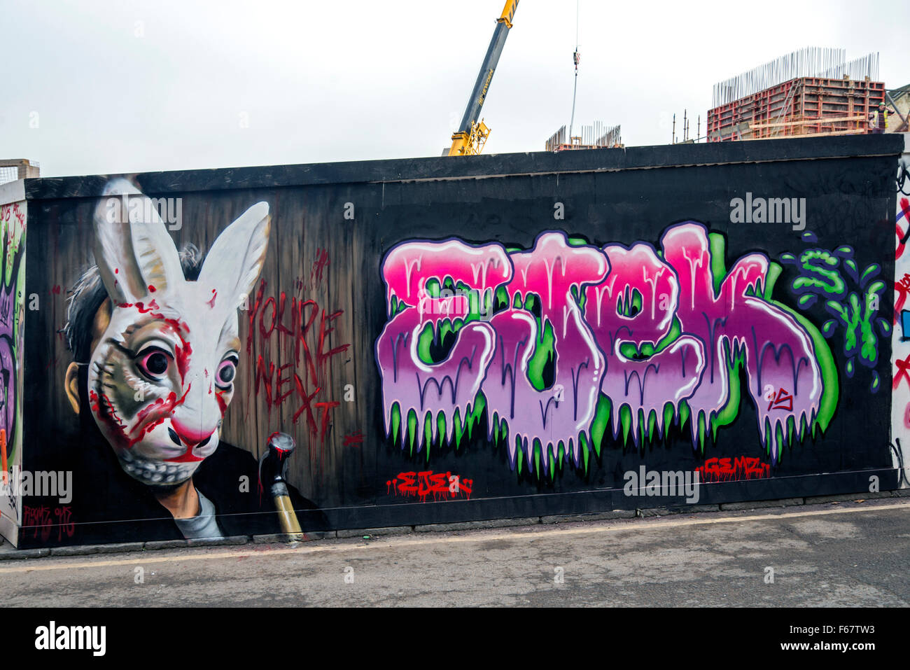 Halloween graffiti featuring a man in a bloodied rabbit mask and holding a hammer withe the words 'you're next'. Stock Photo