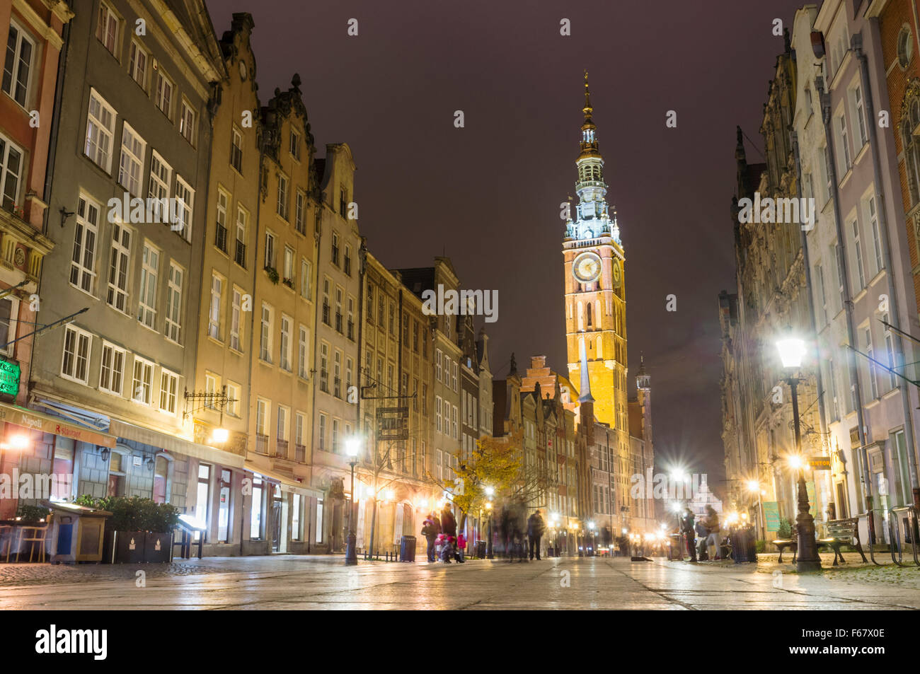 Long Lane and clock tower of city council by night. Gdansk, Poland Stock Photo