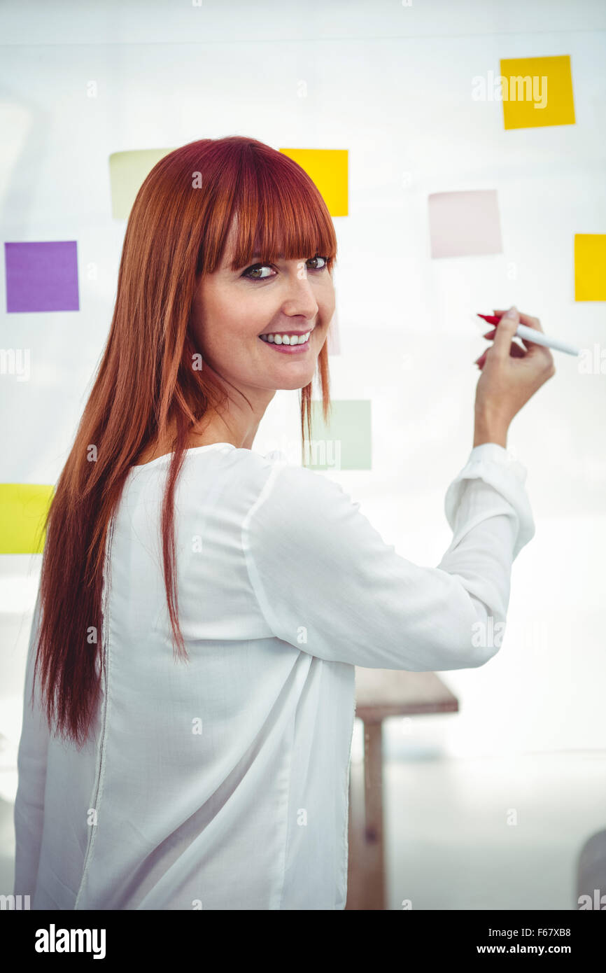 Attractive hipster woman writing on sticky notes Stock Photo - Alamy