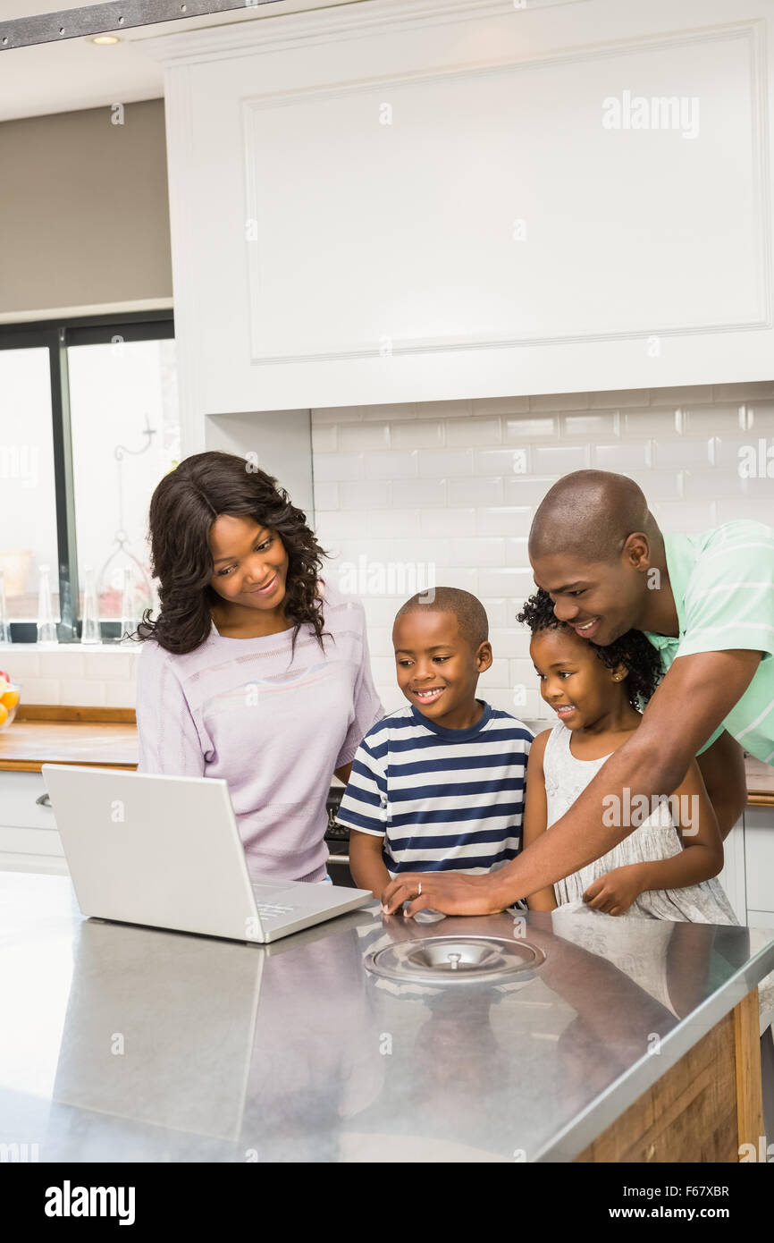 Happy family using laptop Stock Photo - Alamy