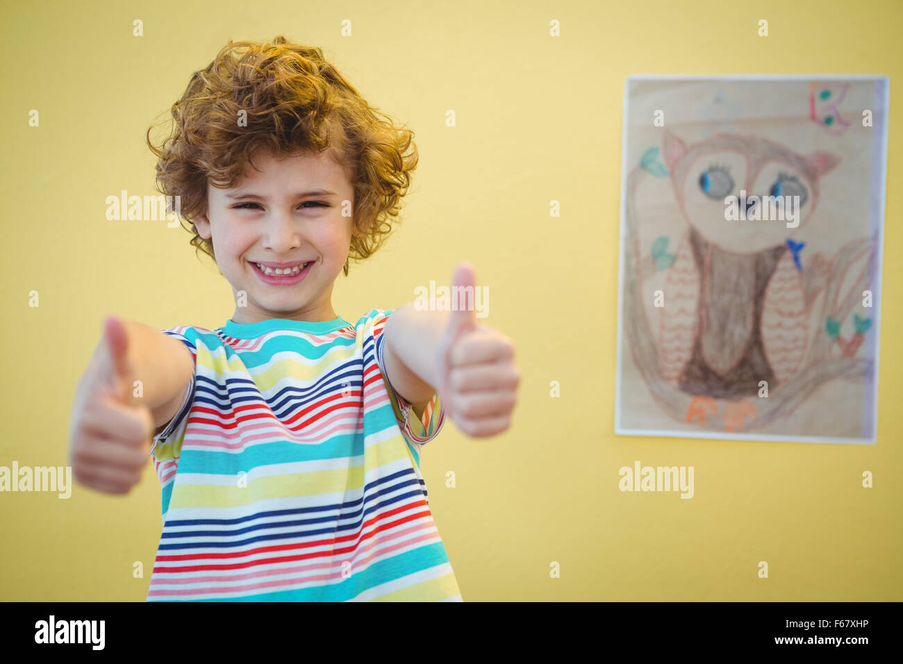 Boy holding his thumbs up Stock Photo