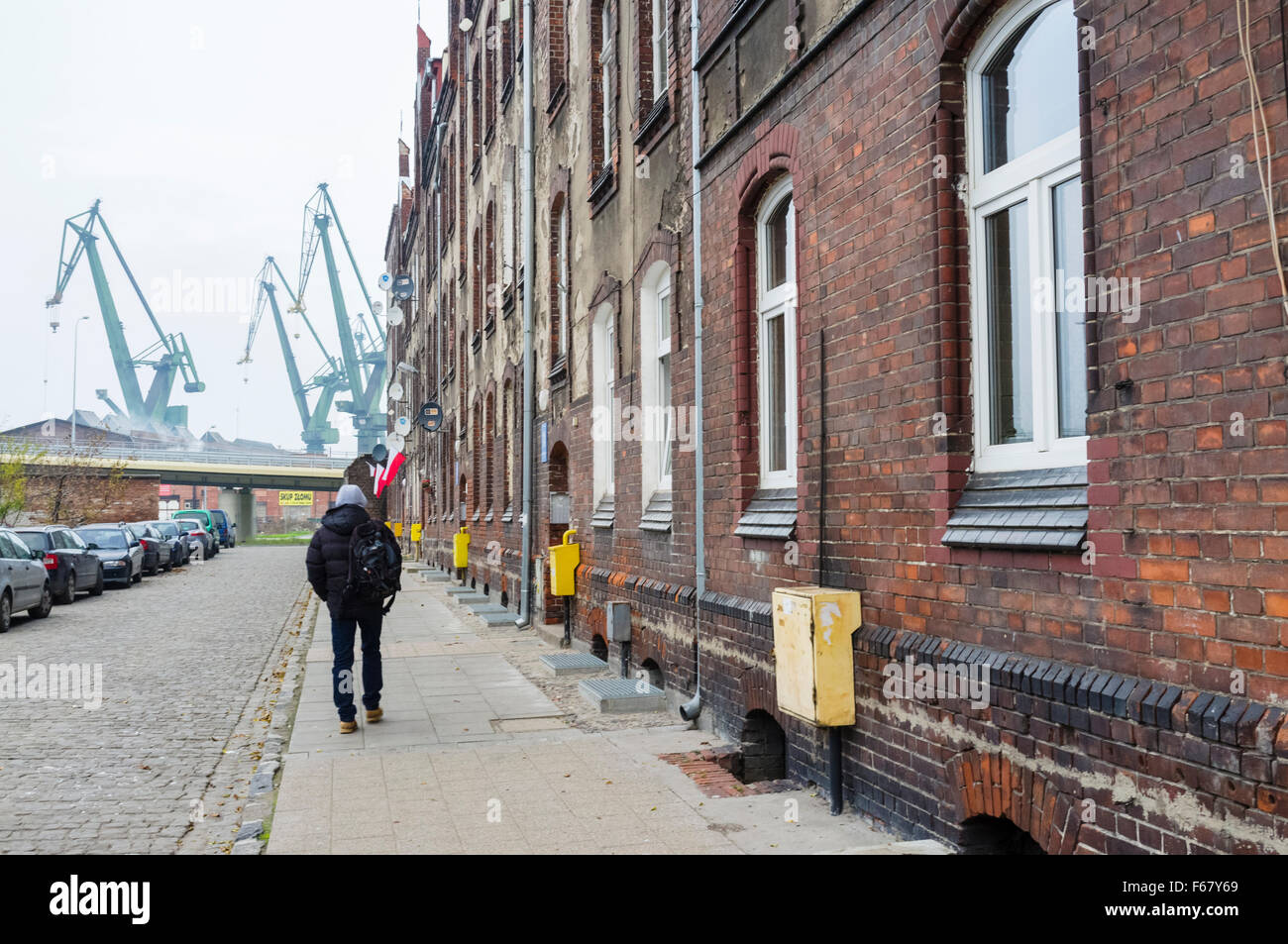Shipyard neighborhood tenements and cranes. Gdansk, Poland Stock Photo