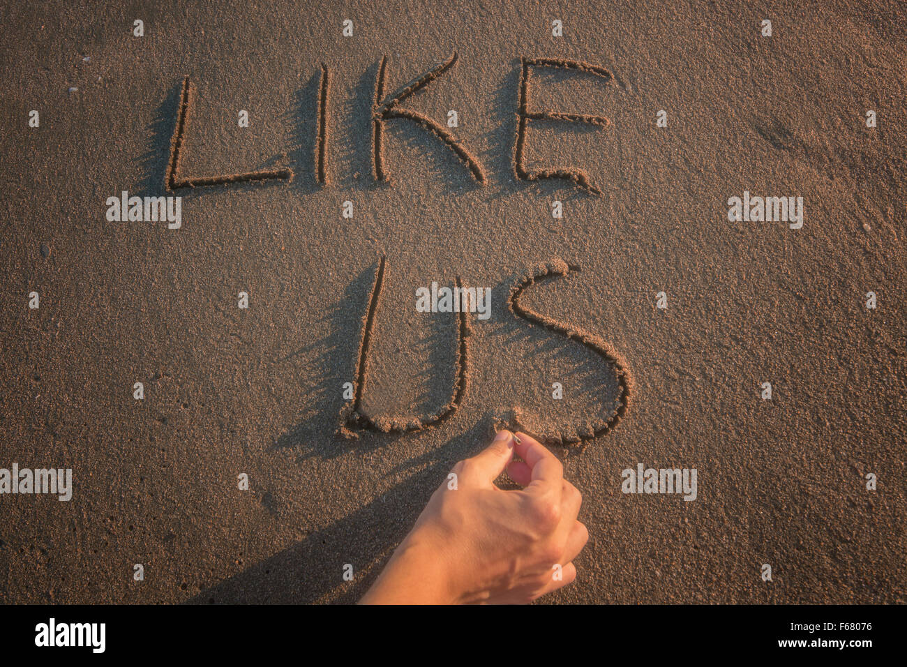 Like - text written by hand in sand on a beach, Stock Photo