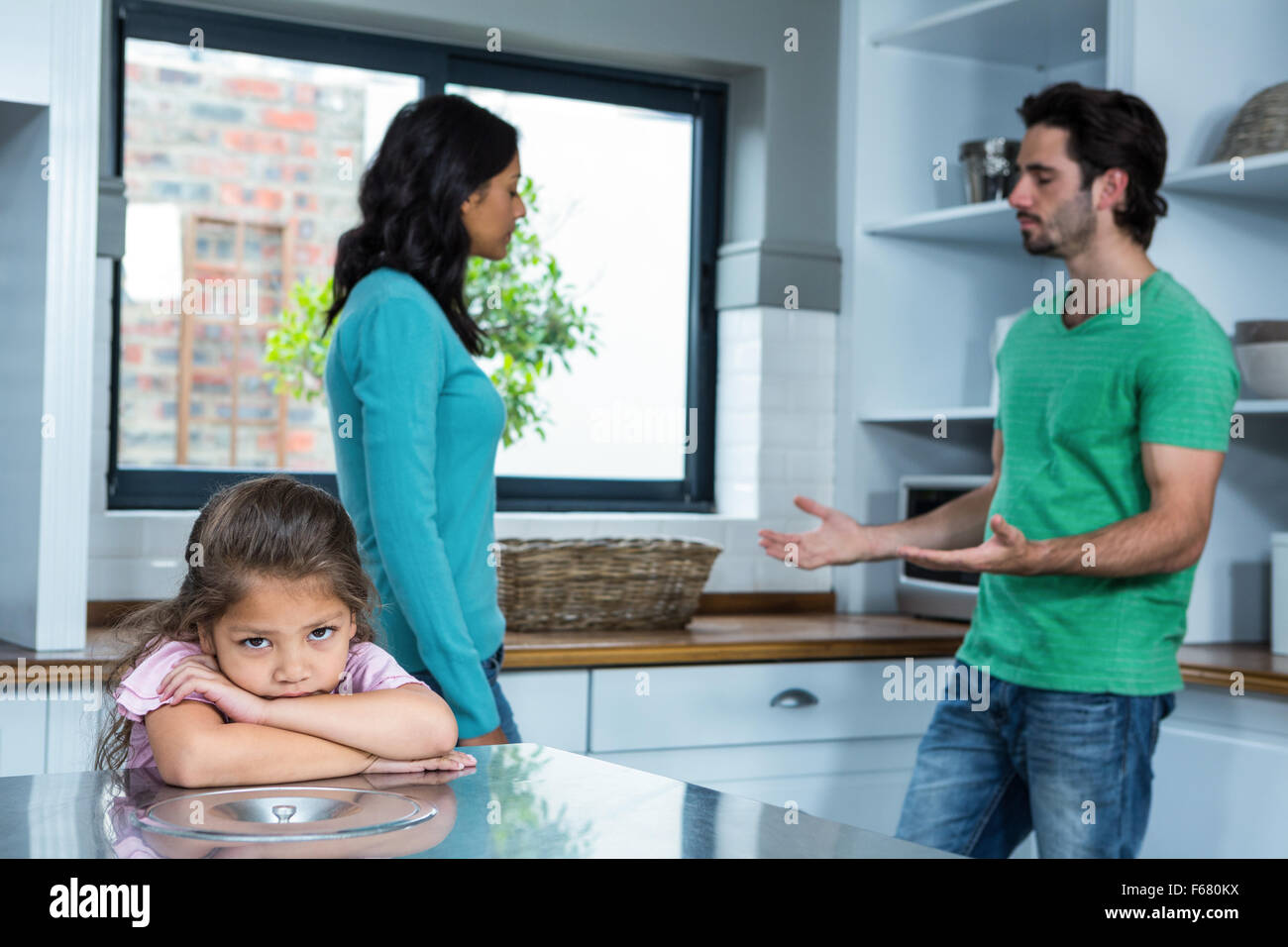 Sad child listening to parents argument Stock Photo