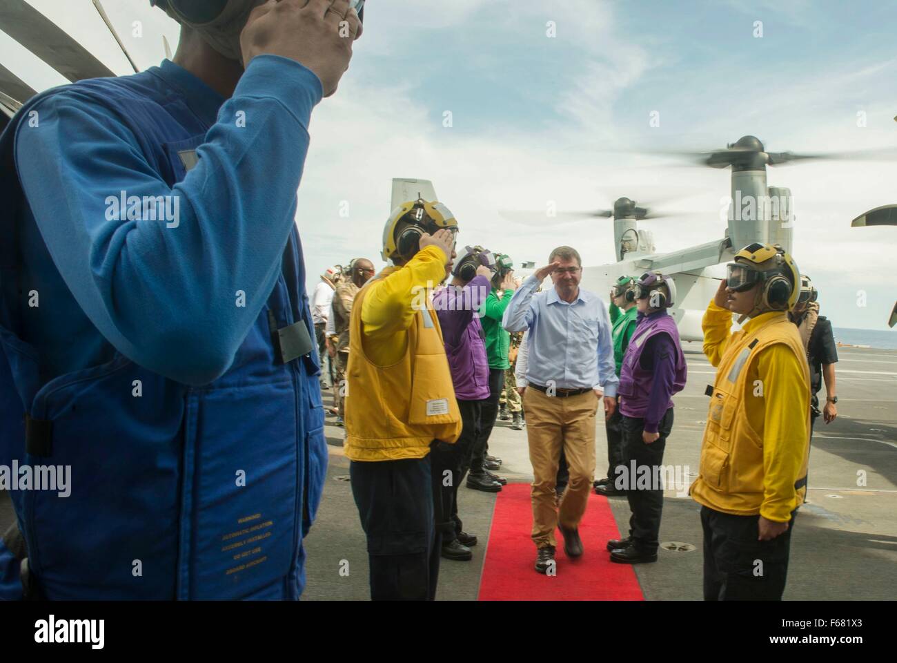 U.S. Secretary of Defense Ash Carter is saluted by U.S. Navy Sailors as he and Malaysian Minister of Defense Hishammuddin Hussein arrive onboard the USS Theodore Roosevelt for a visit November 5, 2015 in the South China Sea. Stock Photo