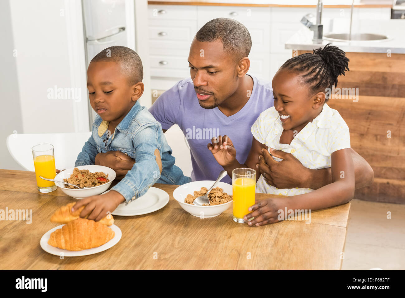 Casual happy family having breakfast Stock Photo - Alamy