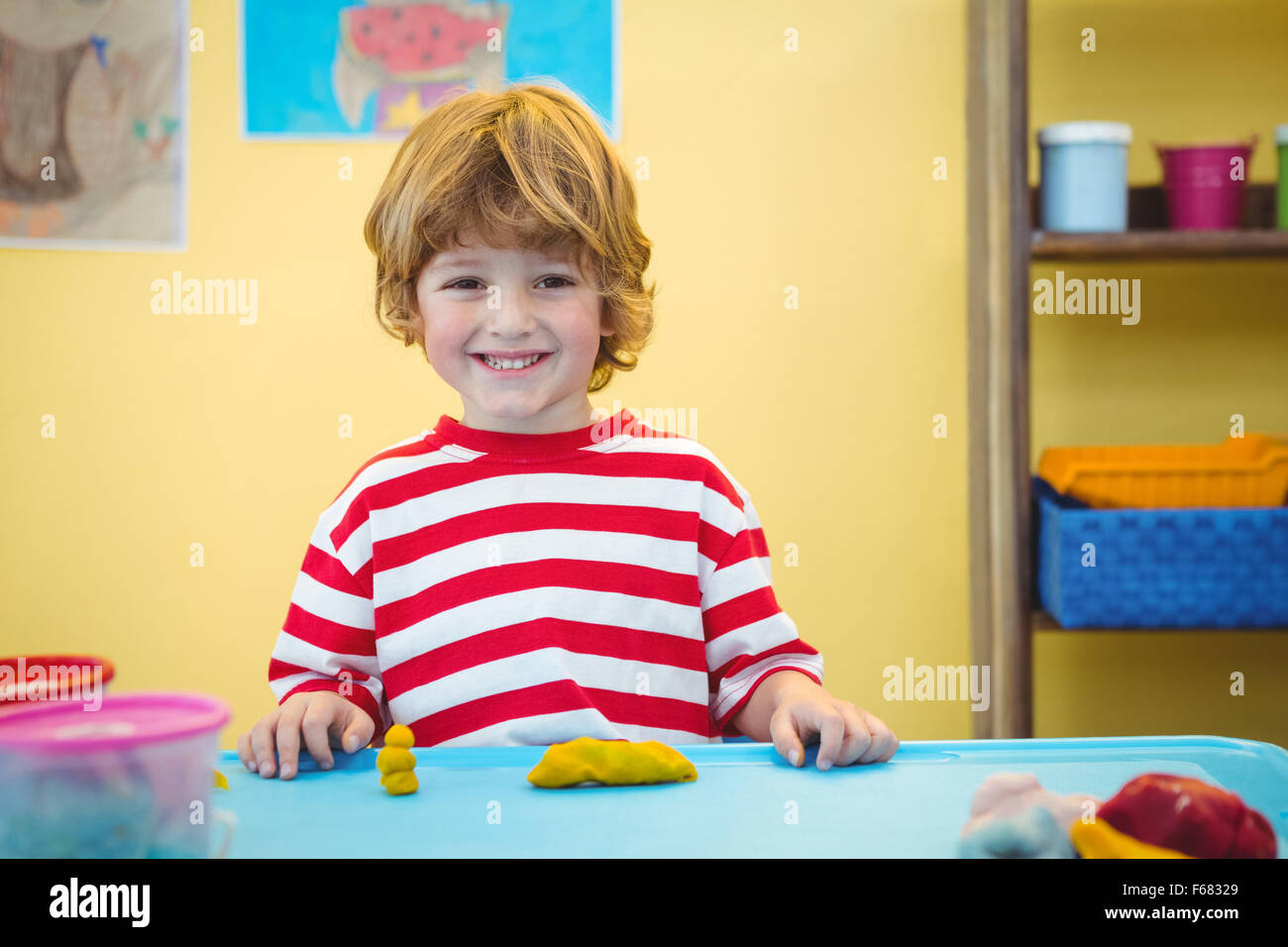 Happy boy with modelling clay Stock Photo