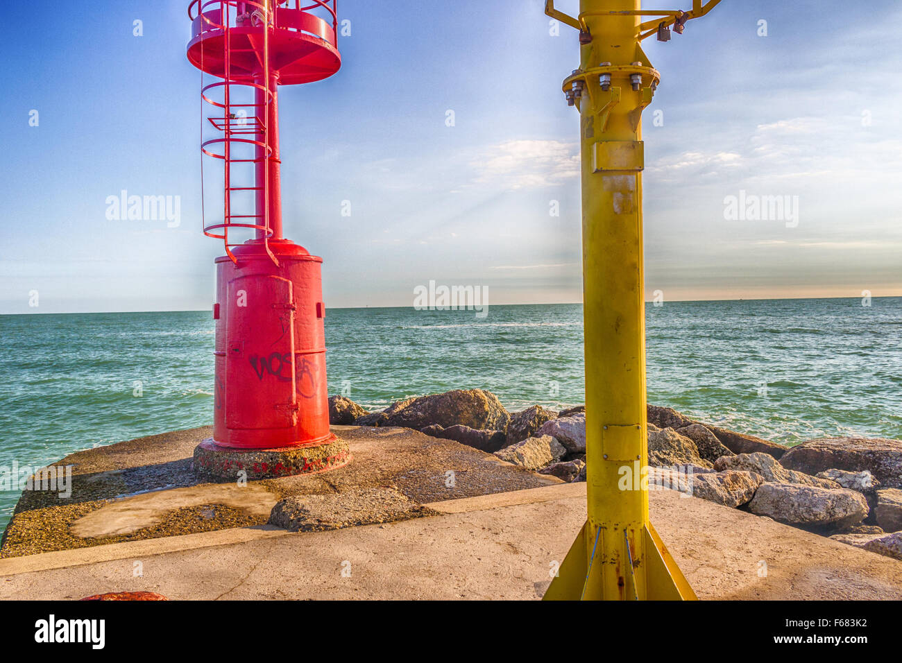 red and yellow lighthouses on a pier on the Adriatic Sea Stock Photo