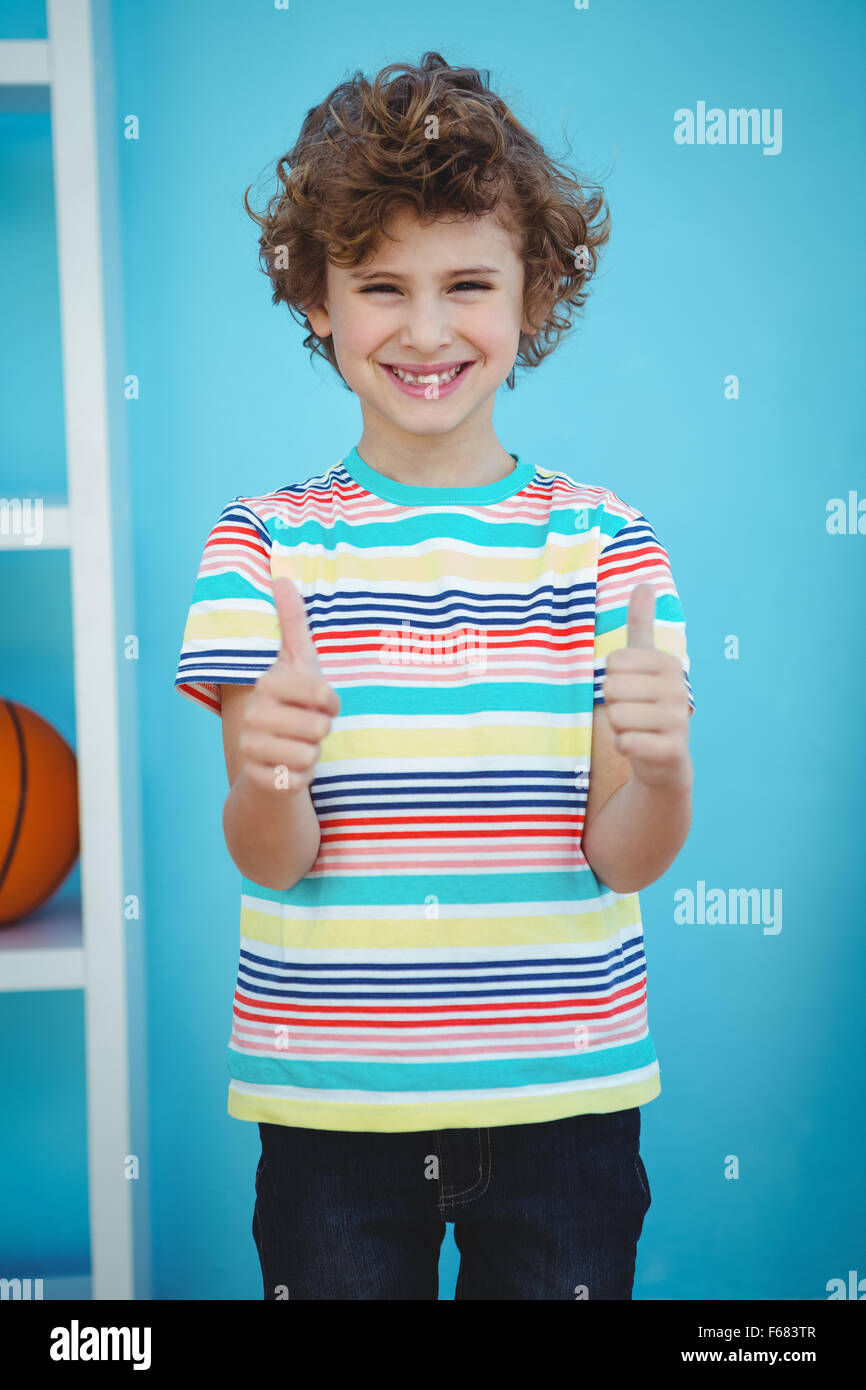 Smiling boy standing with thumbs up Stock Photo - Alamy