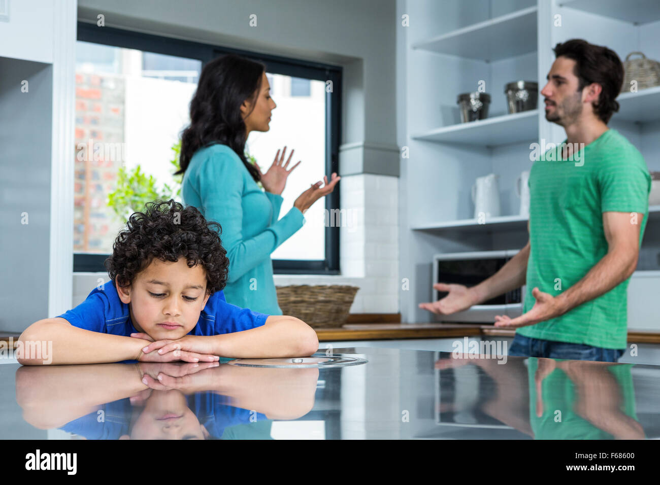 Sad child listening to parents argument Stock Photo - Alamy