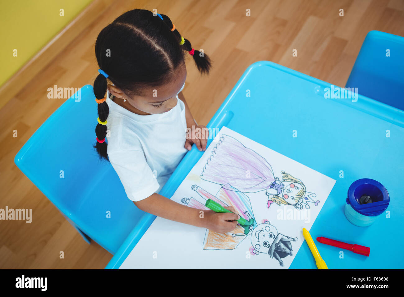 Girl drawing in her colouring book Stock Photo