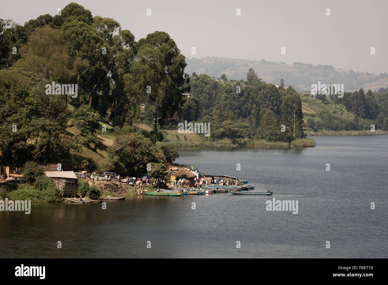 A fisher town at a lake in Uganda Africa with many small fisherboats. Stock Photo