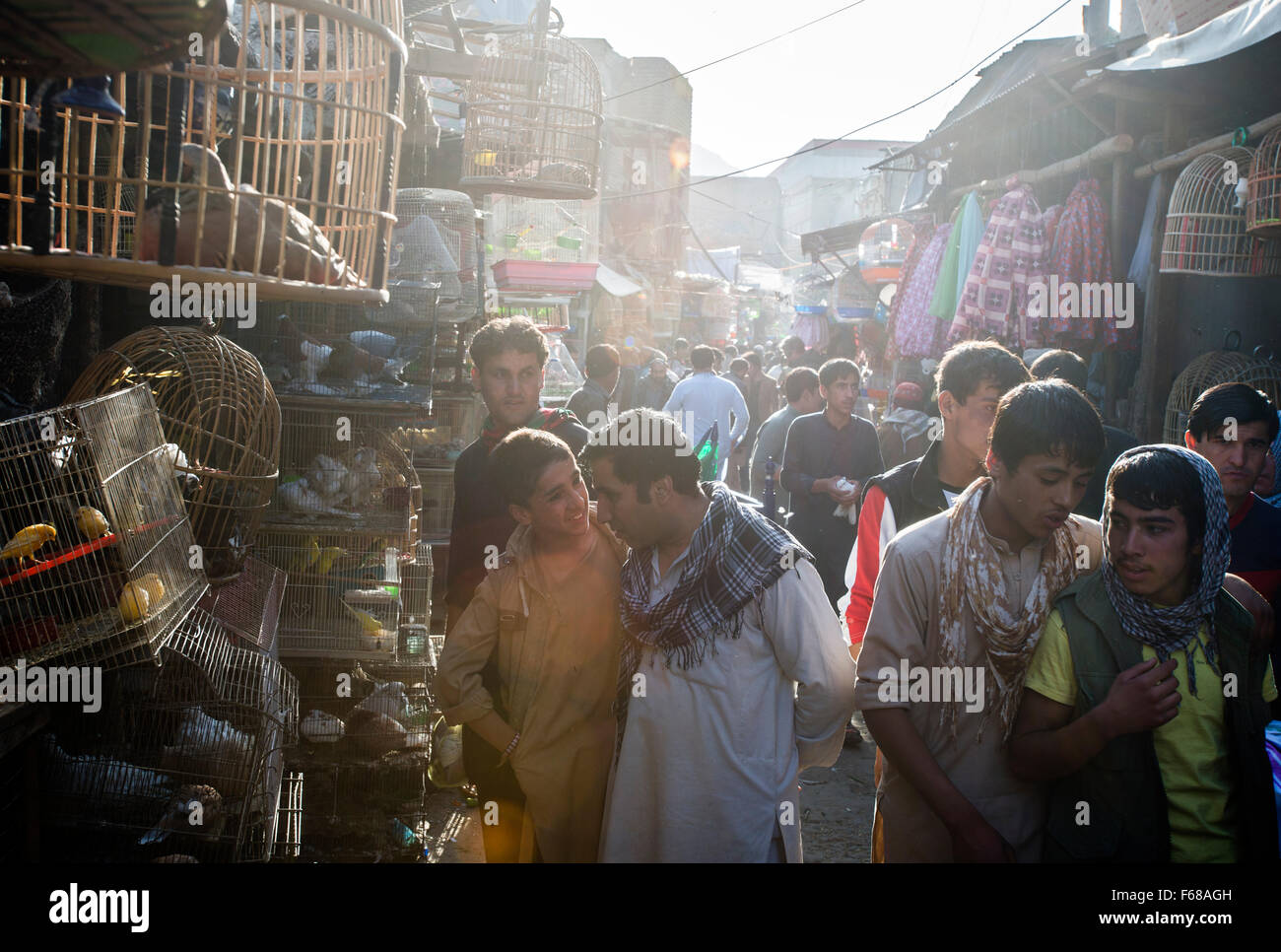 People walking on the narrow alley of birds market in Kabul