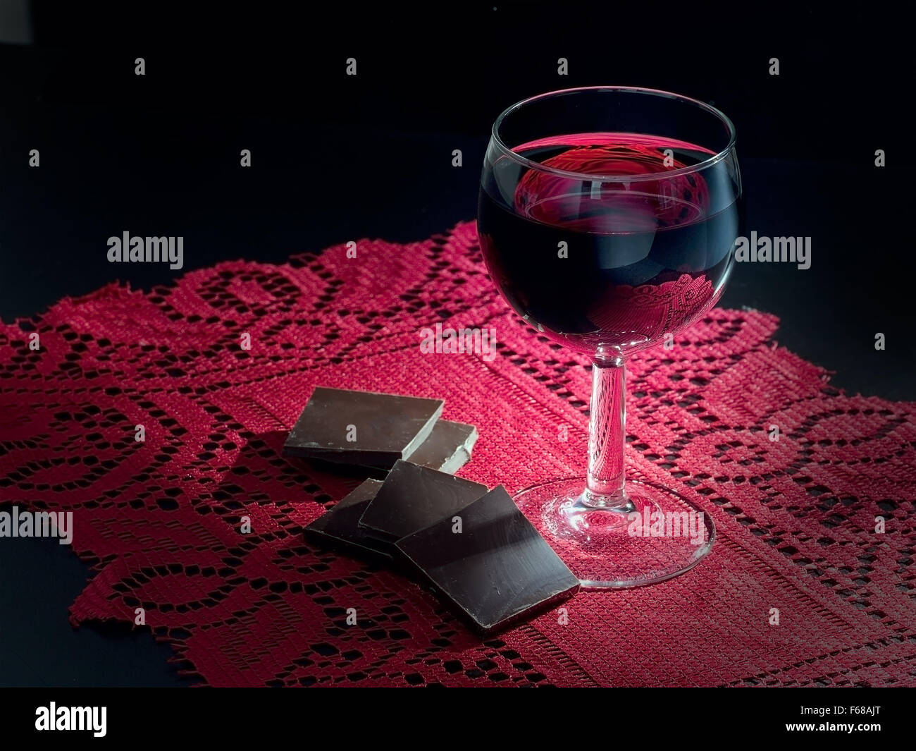 Healthy heart? Dark chocolate and red wine on red lace doily Stock Photo