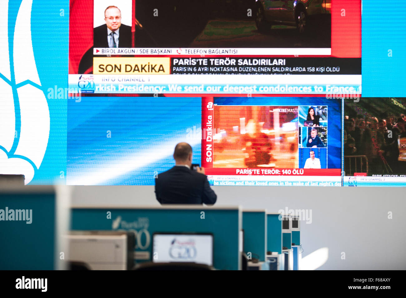Antalya, Mediterranean resort city of Turkey. 13th Nov, 2015. A staff films the news broadcasting Paris attacks on screen at the press center of G20 summit, in Antalya, a Mediterranean resort city of Turkey, on Nov. 13, 2015. French President Francois Hollande canceled his trip to Turkey for the upcoming G20 summit because of the multiple attacks in Paris on Friday. © Pan Chaoyue/Xinhua/Alamy Live News Stock Photo