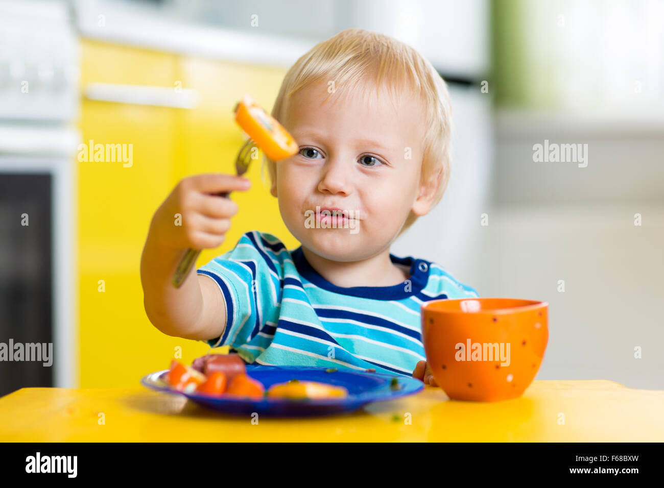 Cute child boy eats healthy food vegetables Stock Photo Alamy