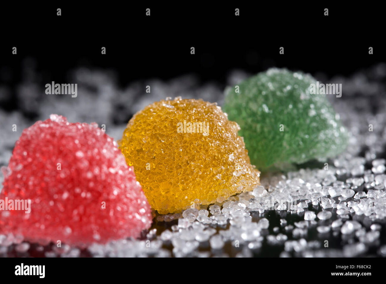 Colorful jelly candies with sugar over dark background Stock Photo - Alamy