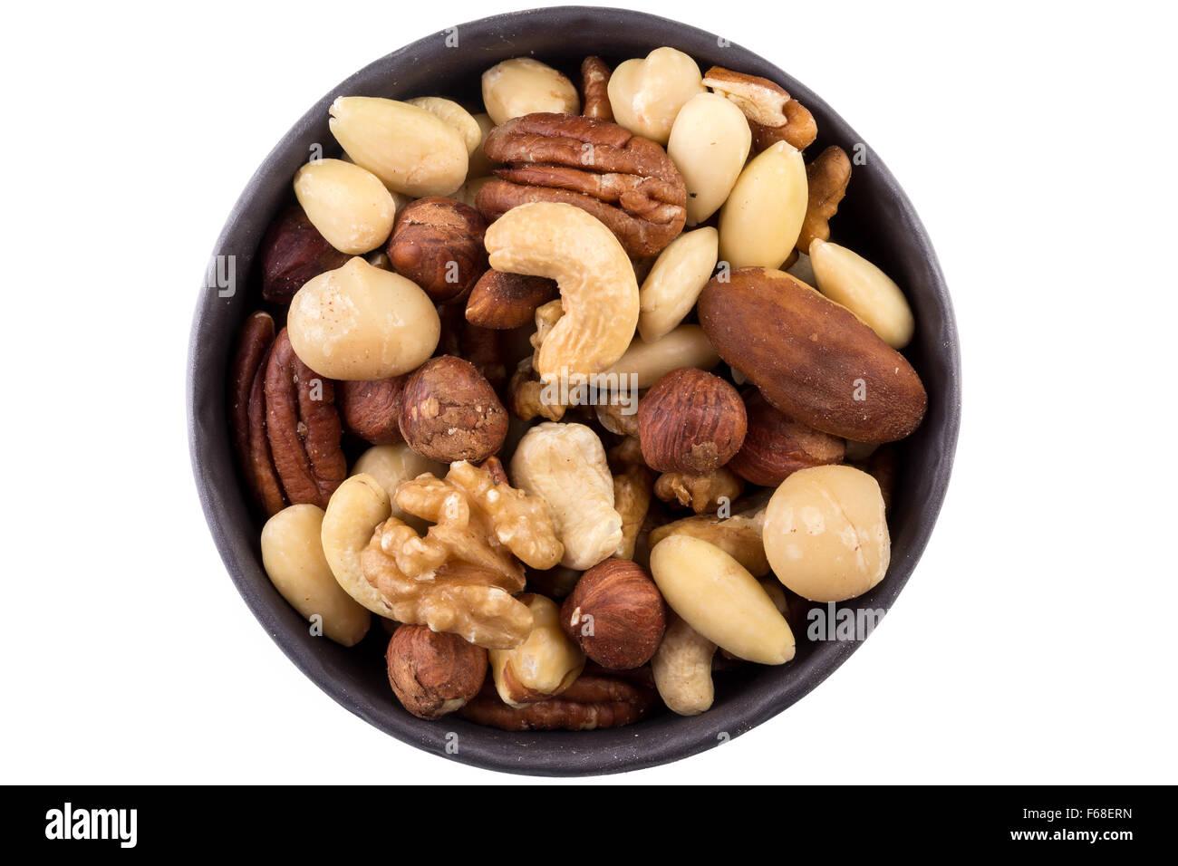 Large diversity of healthy nuts in a dark bowl - isolated Stock Photo