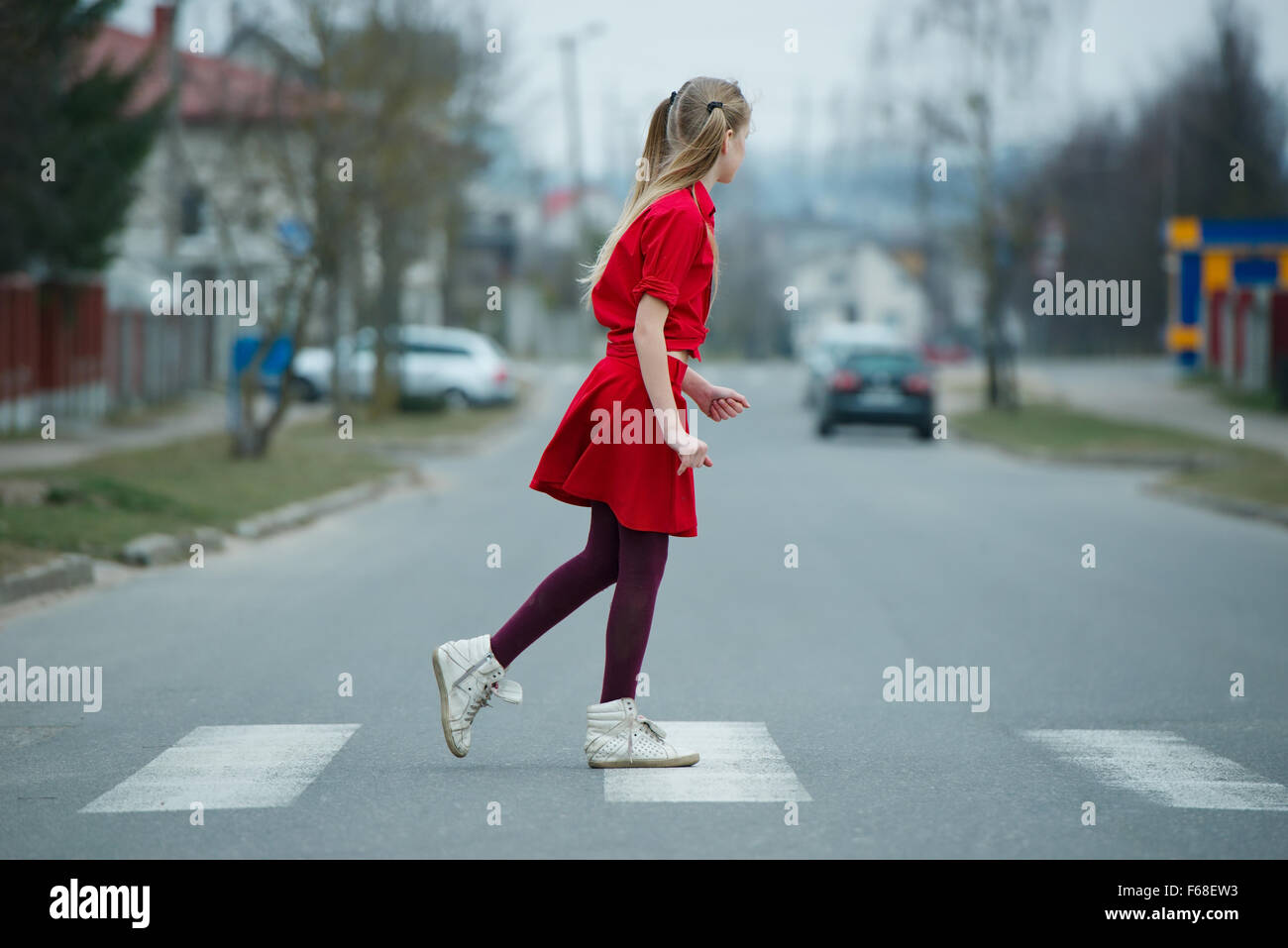 children crossing street on crosswalk Stock Photo