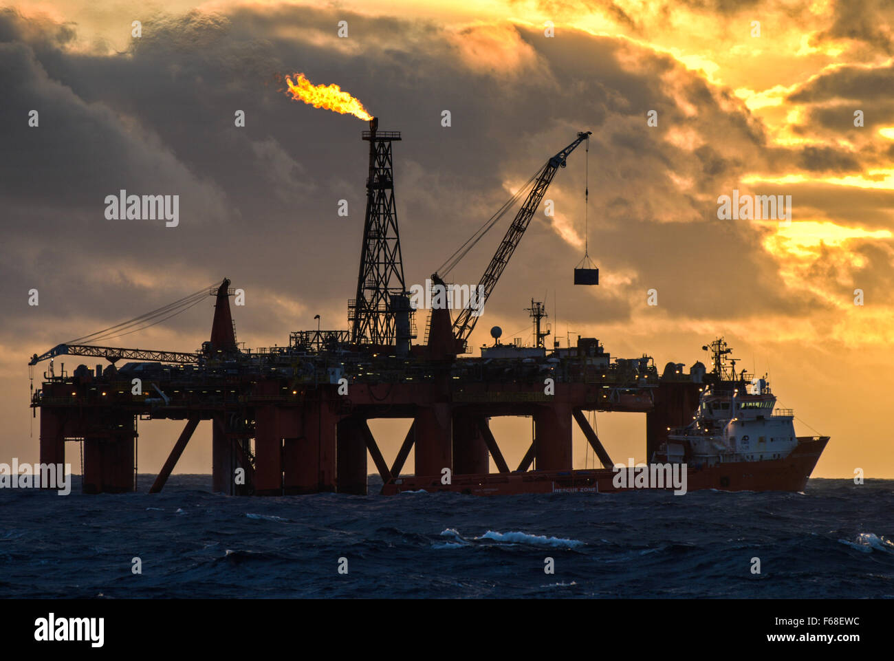Oil rig and supply vessel in the North Sea Stock Photo