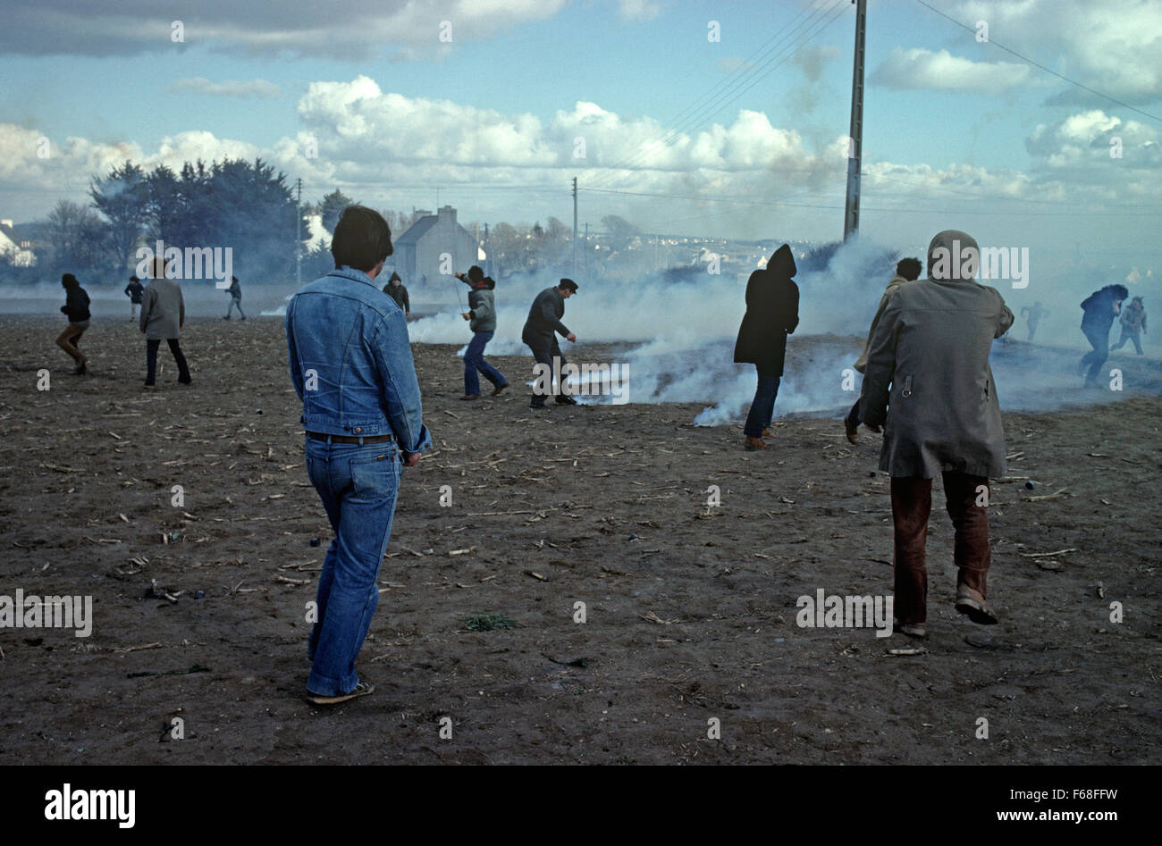 French antinuclear protesters in field with CS gas from French police riot squad, Plogoff, Brittany, France Stock Photo