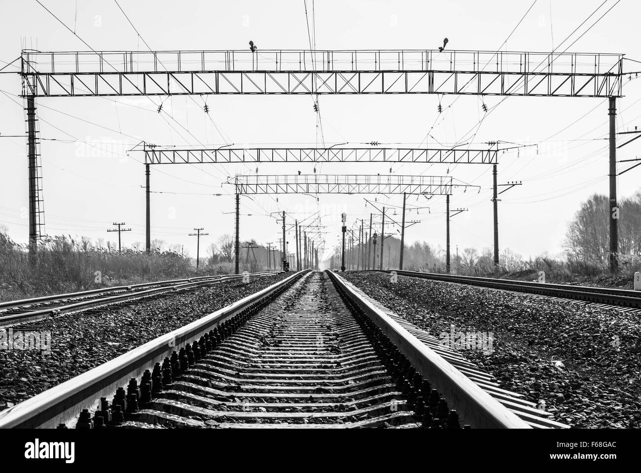 Railroad tracks stretching into the distance beyond the horizon Stock Photo