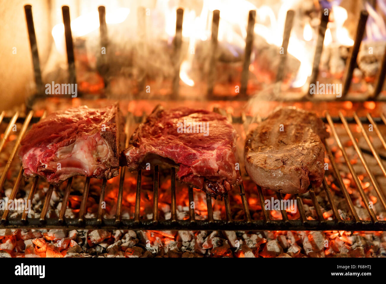 A top sirloin steak flame broiled on a barbecue, shallow depth of field. Stock Photo